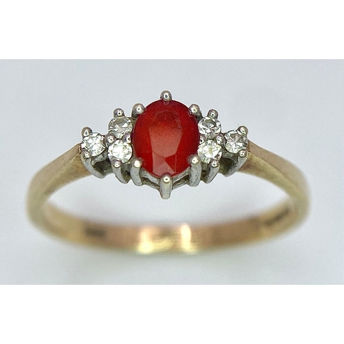 72 - A Vintage 9K Yellow Gold, Red Sapphire and Diamond Ring. Oval sapphire with diamond accents. Size O.... 