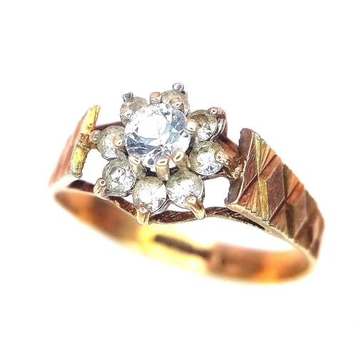 127 - A 9K Yellow Gold Diamond Floral Ring. 0.25ct brilliant round cut central diamond with a diamond halo... 