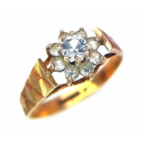 127 - A 9K Yellow Gold Diamond Floral Ring. 0.25ct brilliant round cut central diamond with a diamond halo... 