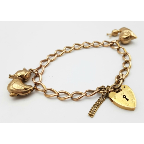 108 - A vintage 9 K rose gold chain bracelet with a padlock clasp and two chams (a snail and a duck). Good... 