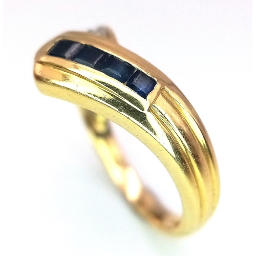 113 - A Stylish 18K Yellow Gold Diamond and Sapphire Crossover Ring. Size L. 3.6g total weight.