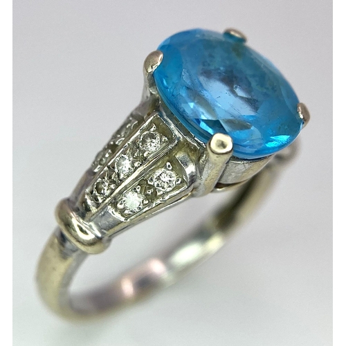 136 - A vintage, 9 K white gold ring with a large, oval cut, vivid blue aquamarine and three bands of diam... 