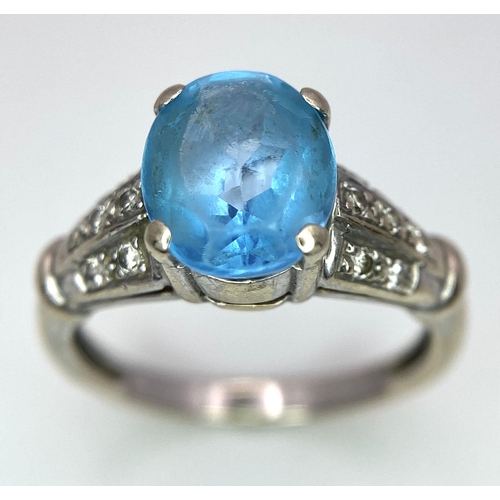 136 - A vintage, 9 K white gold ring with a large, oval cut, vivid blue aquamarine and three bands of diam... 