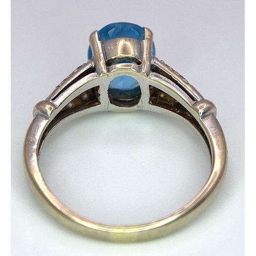 136 - A vintage, 9 K white gold ring with a large, oval cut, vivid blue aquamarine and three bands of diam... 