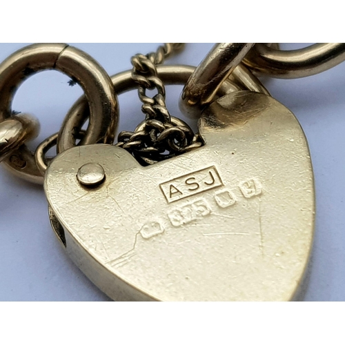66 - A Vintage 9K Yellow Gold Curb Link Bracelet with Heart Clasp. 18cm. 8.4g weight.