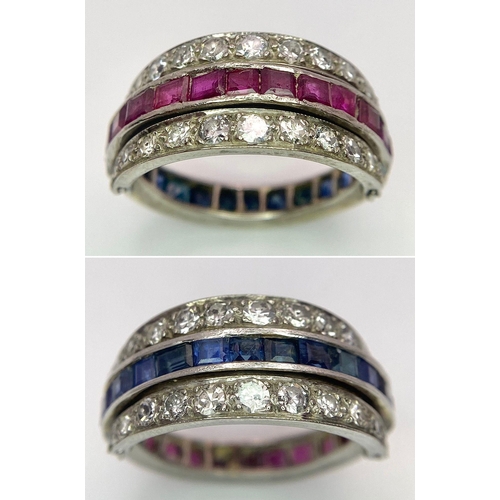 48 - An 9k White Gold Sapphire, Diamond and Ruby Flip-Over Ring. A central band of rubies and sapphires w... 