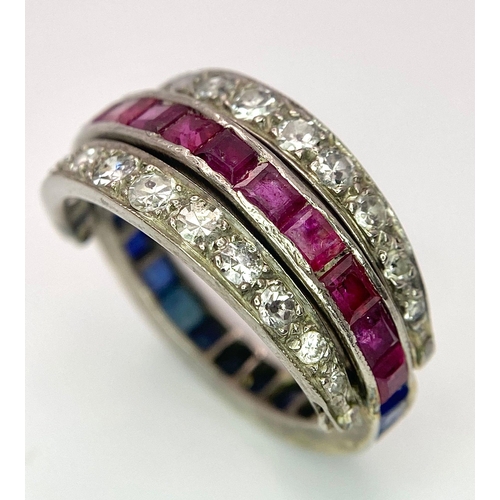 48 - An 9k White Gold Sapphire, Diamond and Ruby Flip-Over Ring. A central band of rubies and sapphires w... 