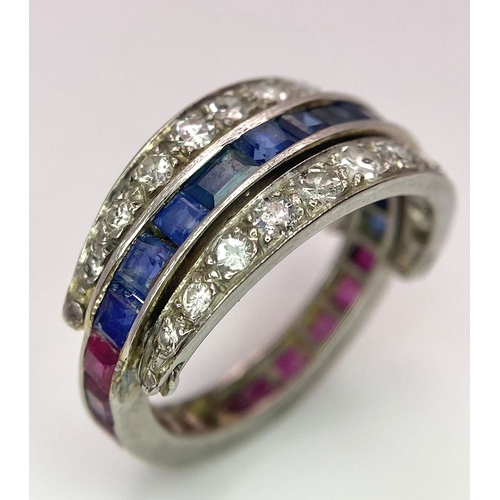 48 - An 9k White Gold Sapphire, Diamond and Ruby Flip-Over Ring. A central band of rubies and sapphires w... 