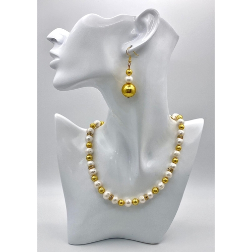 210 - A classy, fresh water cultured white pearl necklace and earrings set, with gold plated parts and cub... 