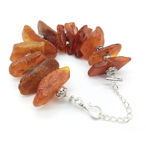 224 - An interesting bracelet consisting of large, 100% natural, cognac coloured, Baltic amber nuggets, in... 