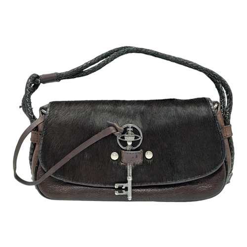 296 - A Vintage Vivienne Westwood Handbag. Brown leather and pony hair exterior. Key clasp. Red textile in... 