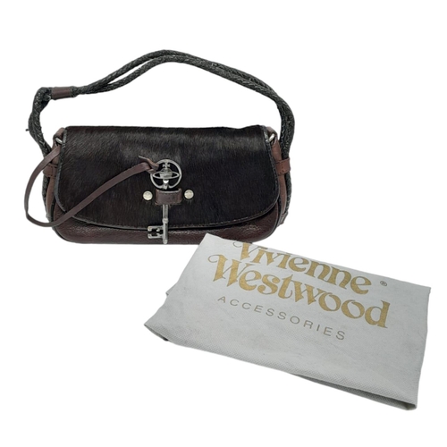 296 - A Vintage Vivienne Westwood Handbag. Brown leather and pony hair exterior. Key clasp. Red textile in... 