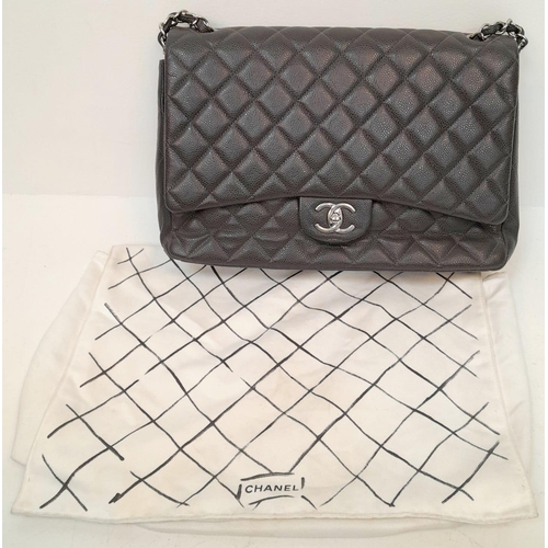 11 - A Chanel Jumbo Double Flap Maxi Bag. Dark grey quilted caviar leather exterior with a large slip poc... 