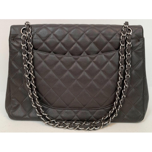 11 - A Chanel Jumbo Double Flap Maxi Bag. Dark grey quilted caviar leather exterior with a large slip poc... 