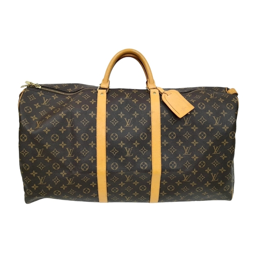 130 - A Louis Vuitton Monogram Keepall 60 Travel Bag. Leather exterior with gold-toned hardware, two rolle... 