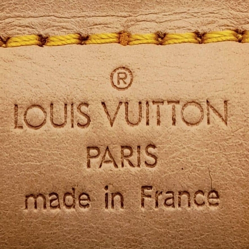 130 - A Louis Vuitton Monogram Keepall 60 Travel Bag. Leather exterior with gold-toned hardware, two rolle... 