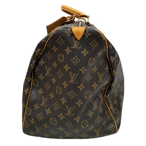 130 - A Louis Vuitton Monogram Keepall 60 Travel Bag. Leather exterior with gold-toned hardware, two rolle... 