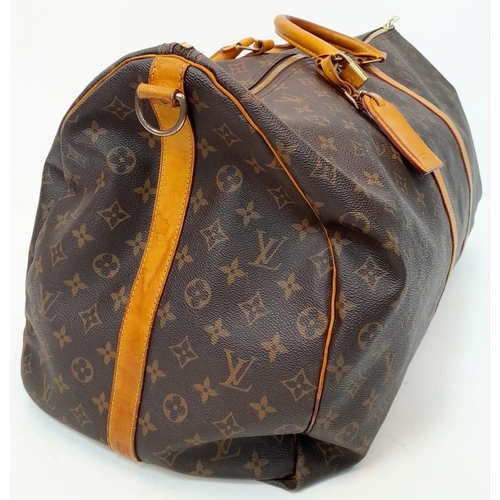 137 - A Large Louis Vuitton Keepall Travel Bag. Monogram LV canvas exterior with cowhide leather handles a... 