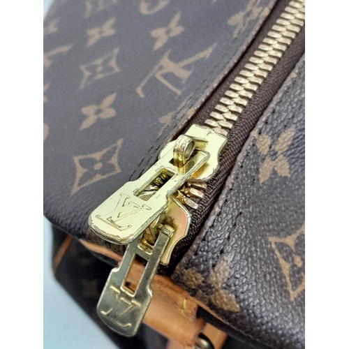 137 - A Large Louis Vuitton Keepall Travel Bag. Monogram LV canvas exterior with cowhide leather handles a... 