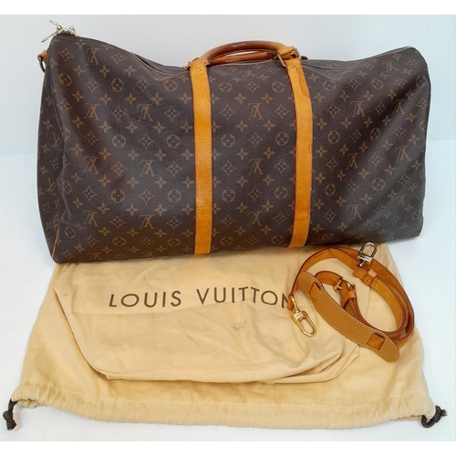 137 - A Large Louis Vuitton Keepall Travel Bag. Monogram LV canvas exterior with cowhide leather handles a... 