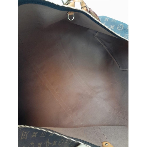 137 - A Large Louis Vuitton Keepall Travel Bag. Monogram LV canvas exterior with cowhide leather handles a... 