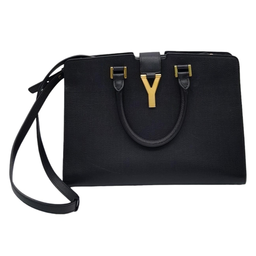 178 - An Yves Saint Laurent Black 'Cabas' Handbag. Leather exterior with gold-toned hardware, two rolled l... 