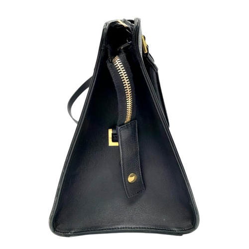 178 - An Yves Saint Laurent Black 'Cabas' Handbag. Leather exterior with gold-toned hardware, two rolled l... 