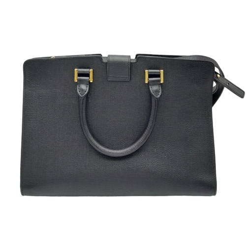 178 - An Yves Saint Laurent Black 'Cabas' Handbag. Leather exterior with gold-toned hardware, two rolled l... 