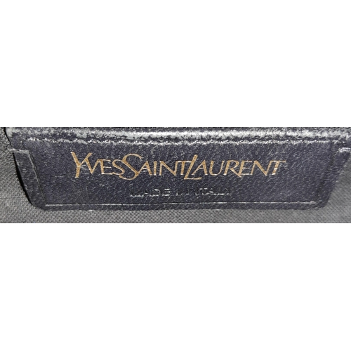 178 - An Yves Saint Laurent Black 'Cabas' Handbag. Leather exterior with gold-toned hardware, two rolled l... 