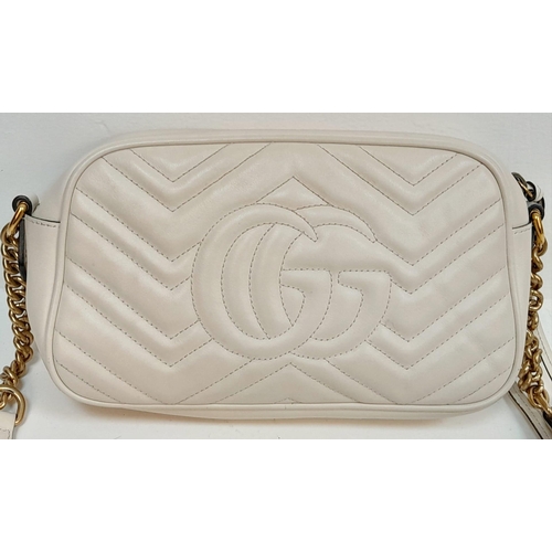 199 - A Gucci Ivory GG Marmont Cross Body Bag. Quilted leather exterior with gold-toned hardware, chain an... 