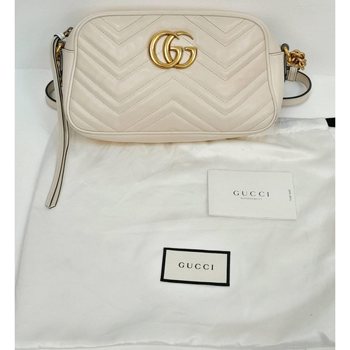 199 - A Gucci Ivory GG Marmont Cross Body Bag. Quilted leather exterior with gold-toned hardware, chain an... 