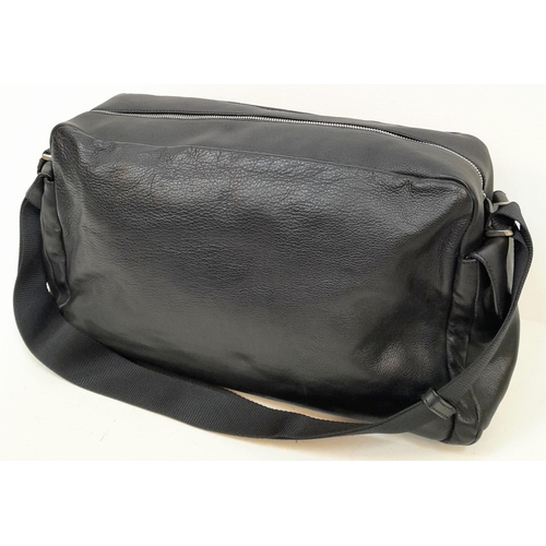 234 - A Prada Black Duffle Bag. Leather exterior with silver-toned hardware, zipped outer compartment to b... 