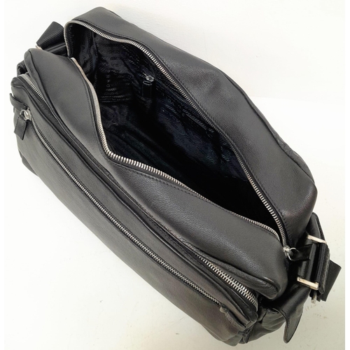 234 - A Prada Black Duffle Bag. Leather exterior with silver-toned hardware, zipped outer compartment to b... 