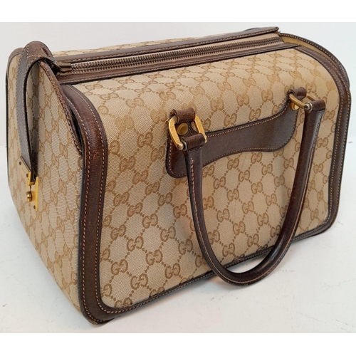 262 - A Gucci Monogram Hard Train Vanity Case. Textile exterior with leather trim, two rolled leather hand... 