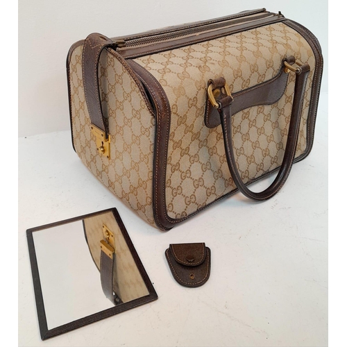 262 - A Gucci Monogram Hard Train Vanity Case. Textile exterior with leather trim, two rolled leather hand... 