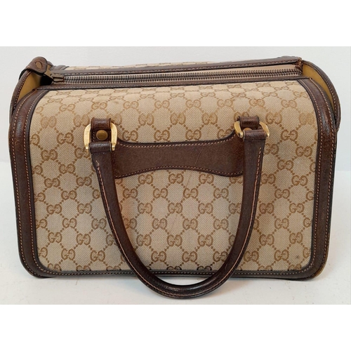 262 - A Gucci Monogram Hard Train Vanity Case. Textile exterior with leather trim, two rolled leather hand... 