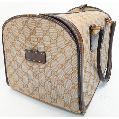 262 - A Gucci Monogram Hard Train Vanity Case. Textile exterior with leather trim, two rolled leather hand... 