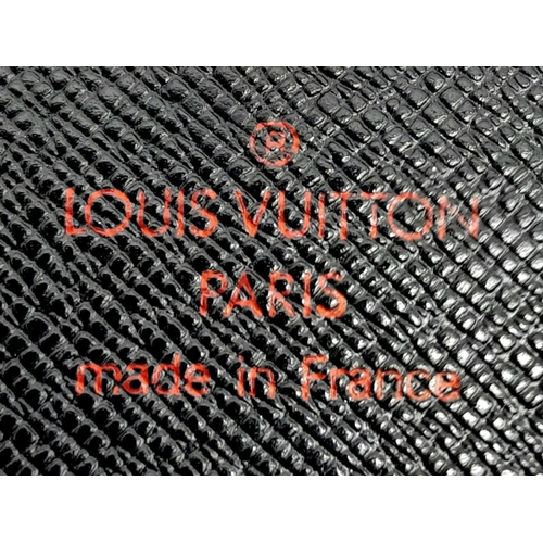 298 - A Louis Vuitton Black 'Sarah' Wallet. Epi leather exterior with the LV logo and press stud closure. ... 
