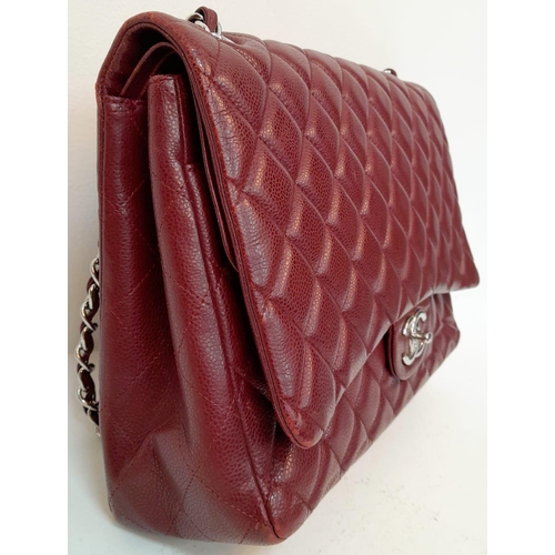 39 - A Chanel Burgundy Jumbo Classic Double Flap Bag. Quilted leather exterior with silver-toned hardware... 