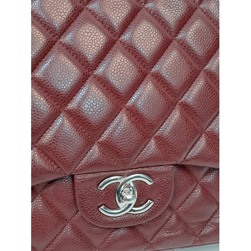 39 - A Chanel Burgundy Jumbo Classic Double Flap Bag. Quilted leather exterior with silver-toned hardware... 