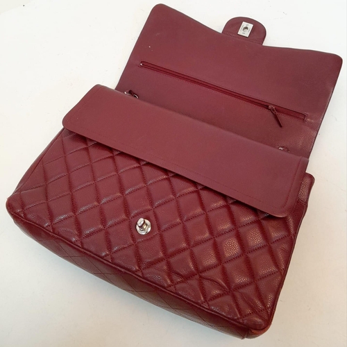 39 - A Chanel Burgundy Jumbo Classic Double Flap Bag. Quilted leather exterior with silver-toned hardware... 