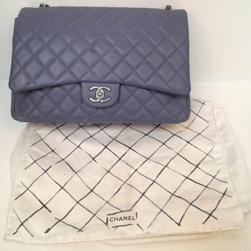 46 - A Chanel Jumbo Double Flap Maxi Bag. Blue quilted caviar leather exterior with a large slip pocket a... 