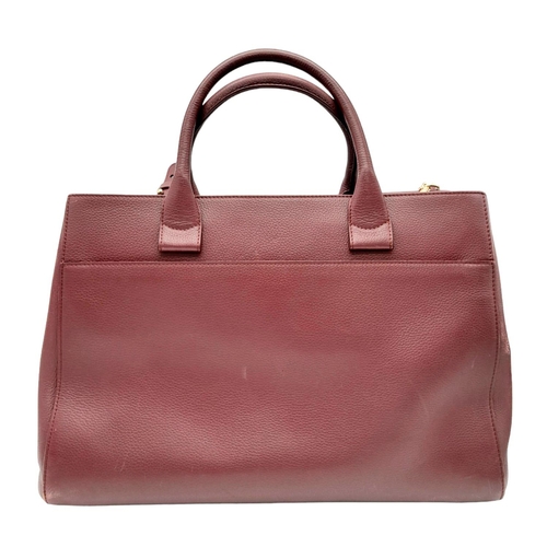 74 - A Chanel Neo Executive Leather Tote Bag. Burgundy leather exterior with gold tone hardware and two l... 