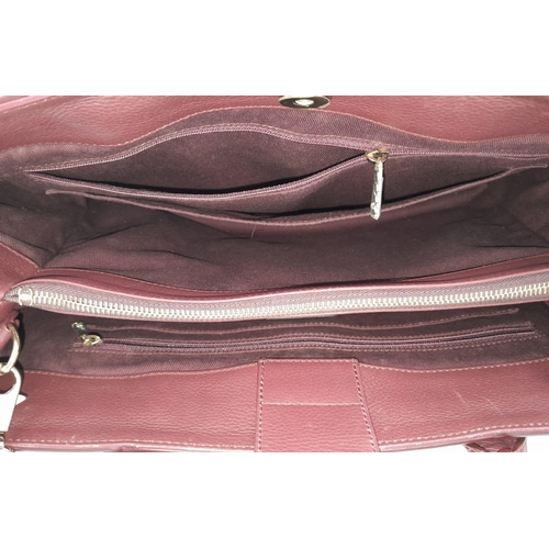 74 - A Chanel Neo Executive Leather Tote Bag. Burgundy leather exterior with gold tone hardware and two l... 