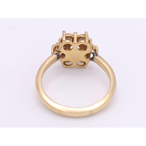 103 - AN 18K YELLOW GOLD DIAMOND CLUSTER RING. 1.20CTW OF ROUND BRILIANT CUT DIAMONDS. 3.9G. SIZE L.