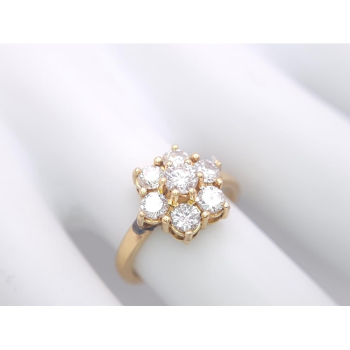 103 - AN 18K YELLOW GOLD DIAMOND CLUSTER RING. 1.20CTW OF ROUND BRILIANT CUT DIAMONDS. 3.9G. SIZE L.