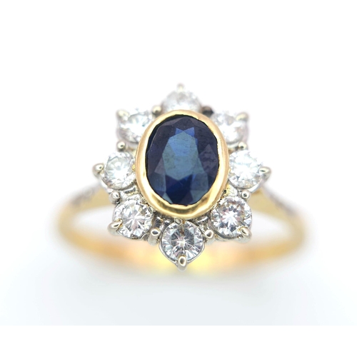 138 - AN 18K YELLOW GOLD DIAMOND & SAPPHIRE CLUSTER RING. 0.60CTW ROUND BRIILIANT CUT DIMAONDS & 0.80CT OV... 