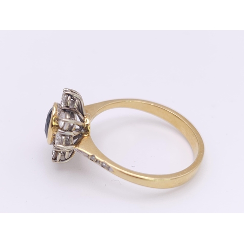 138 - AN 18K YELLOW GOLD DIAMOND & SAPPHIRE CLUSTER RING. 0.60CTW ROUND BRIILIANT CUT DIMAONDS & 0.80CT OV... 