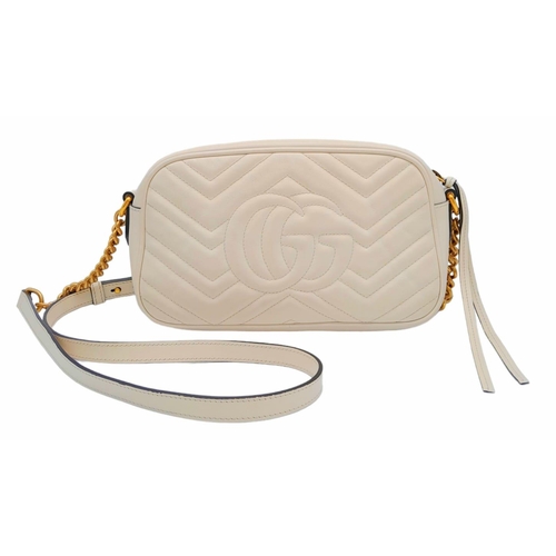 199 - A Gucci Ivory GG Marmont Cross Body Bag. Quilted leather exterior with gold-toned hardware, chain an... 