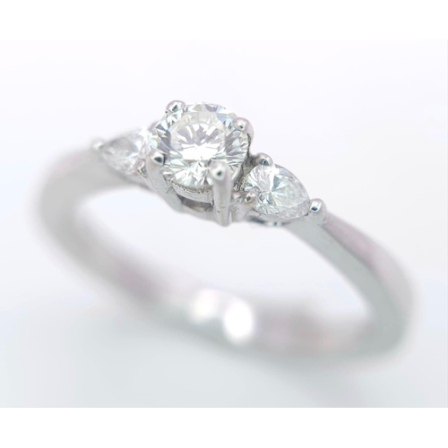 75 - AN 18K WHITE GOLD DIAMOND RING WITH PEAR SHAPED DIAMOND ACCENTS ON SHOULDERS. 0.40CTW OF PEAR SHAPED... 